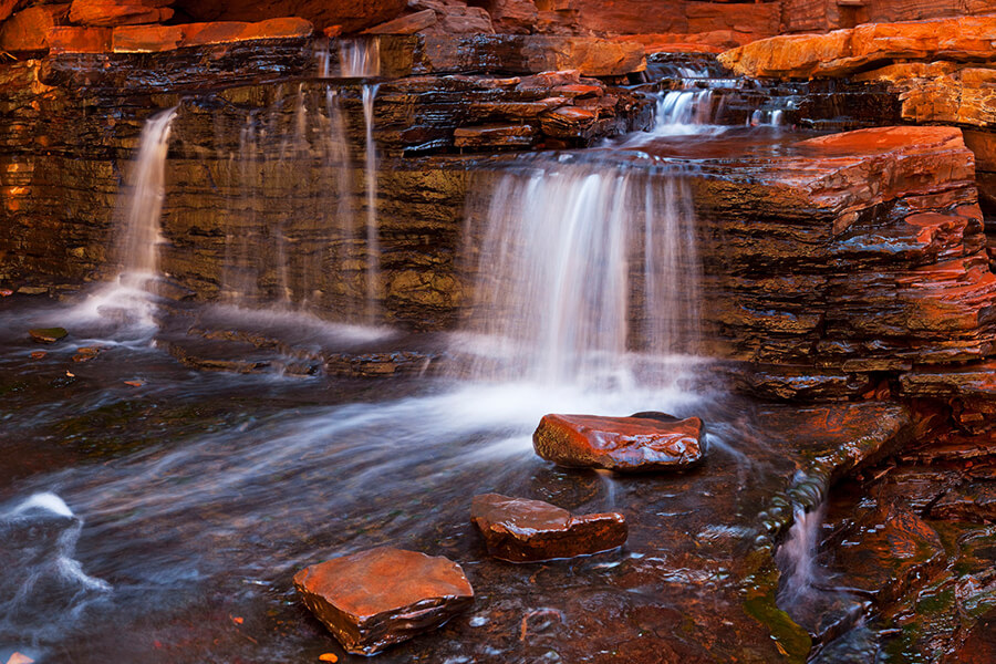 Discover the beautiful landscapes like this waterfall in the Hancock Gorge, Karijini National Park in Western Australia.